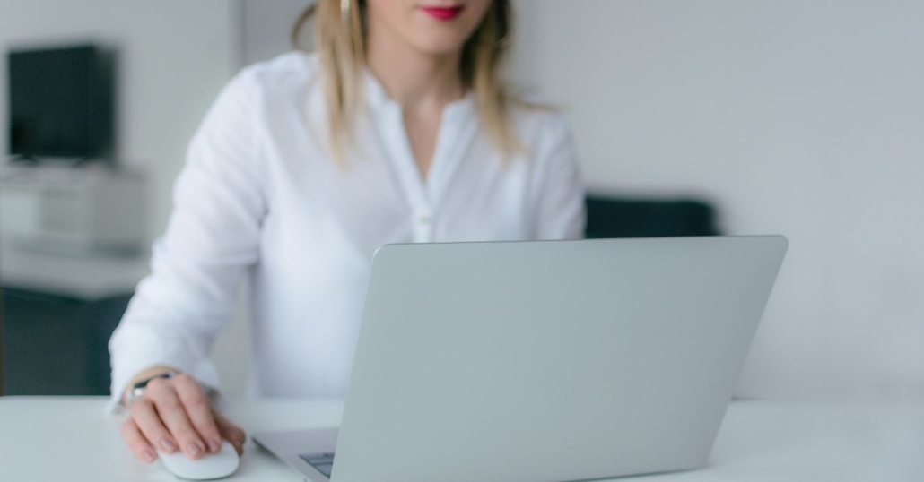 Woman using laptop to illustrate software cost savings