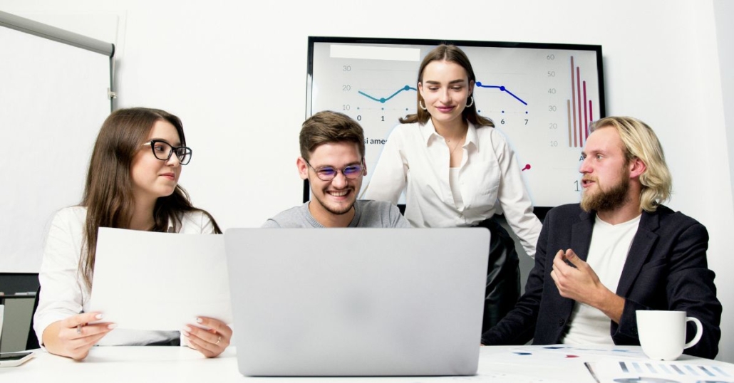 Cost management - communication. Group of people looking at laptop screen