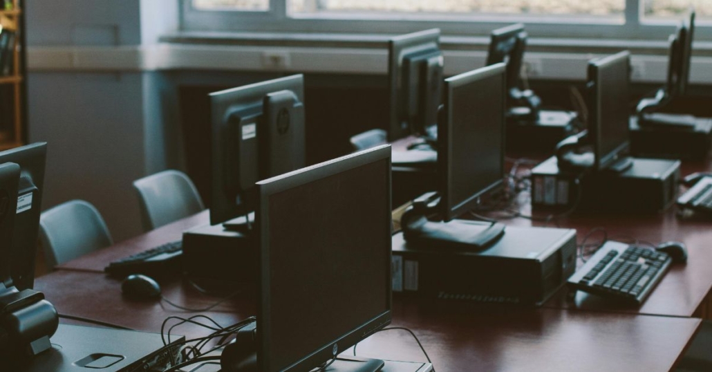 long table with desktop computers to illustrate IT projects that could benefit from staff augmentation