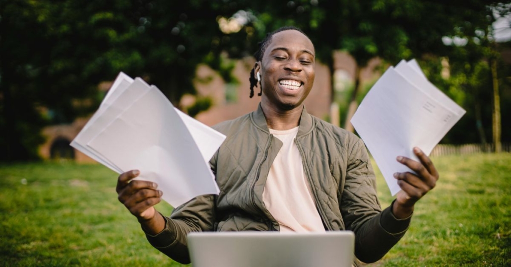 Smiling man holding paperwork