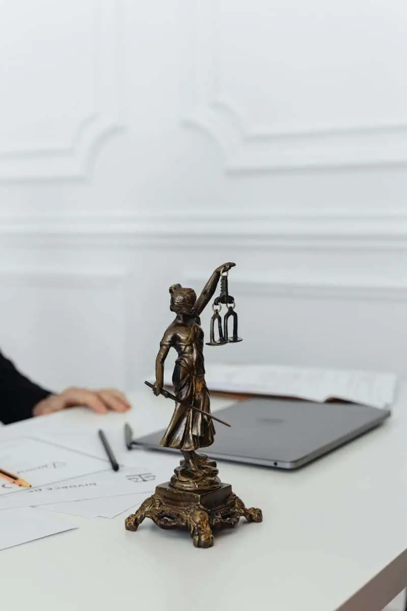 Desk with statue and laptop