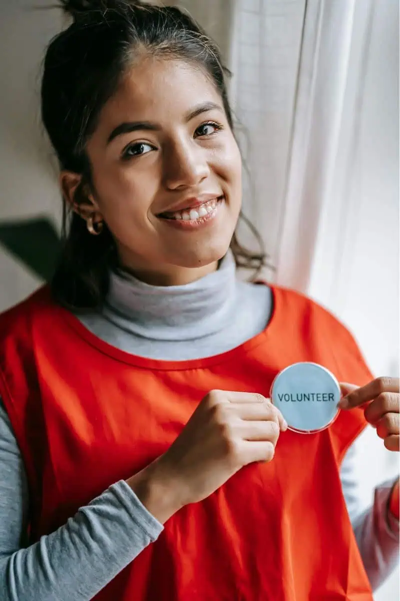 Woman wearing a "volunteer' button